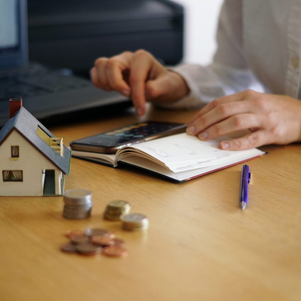 Closeup shot of a person thinking of buying or selling a house A closeup shot of a person thinking of buying or selling a house